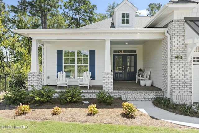 doorway to property featuring french doors and covered porch