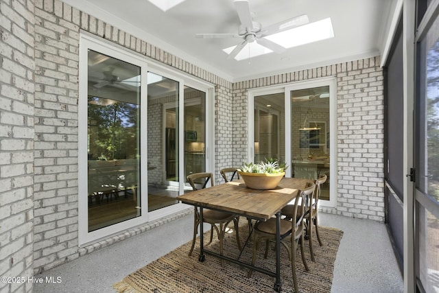 sunroom featuring ceiling fan and a skylight