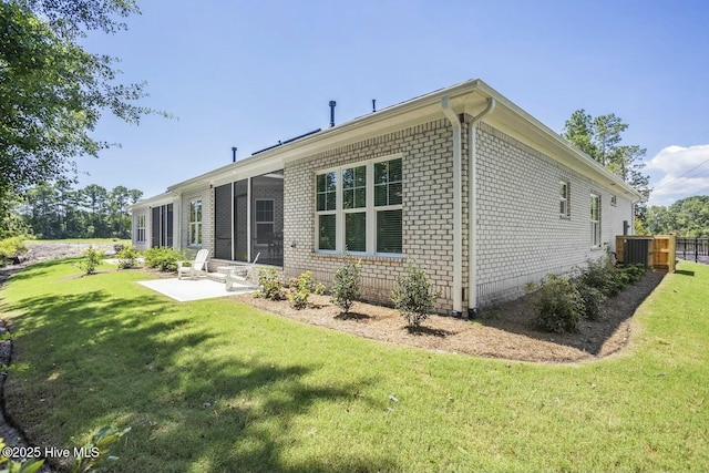 back of property featuring a patio area and a lawn