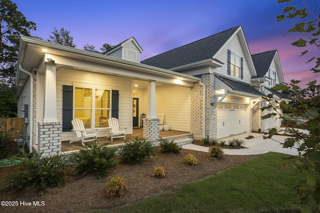 view of front of property featuring a porch and a garage