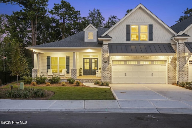 craftsman house with a garage and covered porch