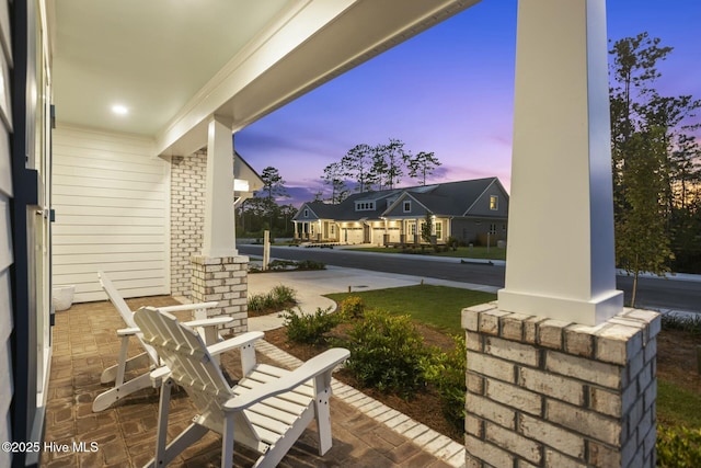 patio terrace at dusk with covered porch