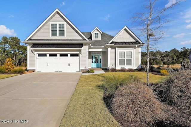 craftsman inspired home featuring a front yard and a garage