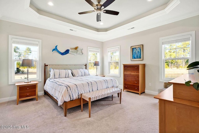 bedroom with a raised ceiling, ceiling fan, light carpet, and crown molding