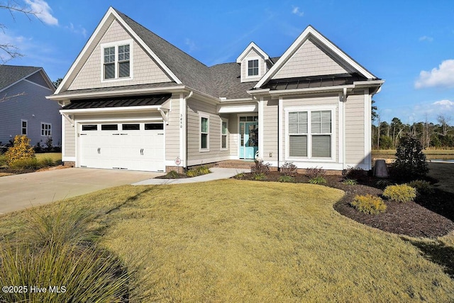 craftsman house with a front lawn and a garage