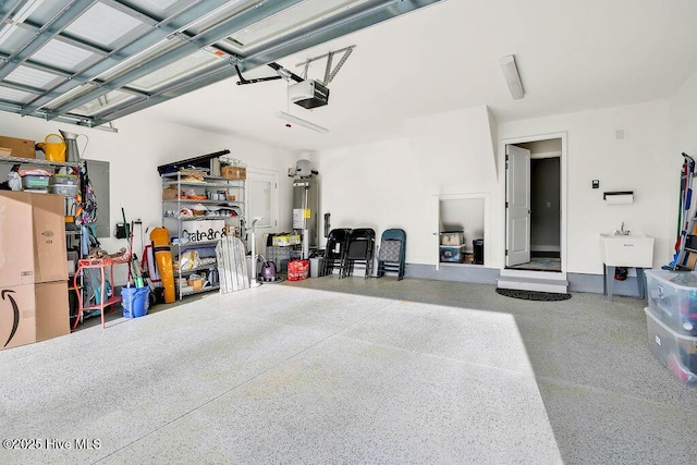 garage featuring a garage door opener, sink, and gas water heater