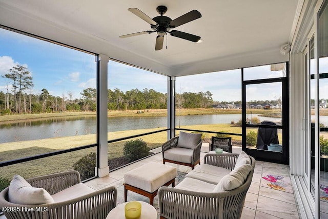 sunroom / solarium with ceiling fan and a water view