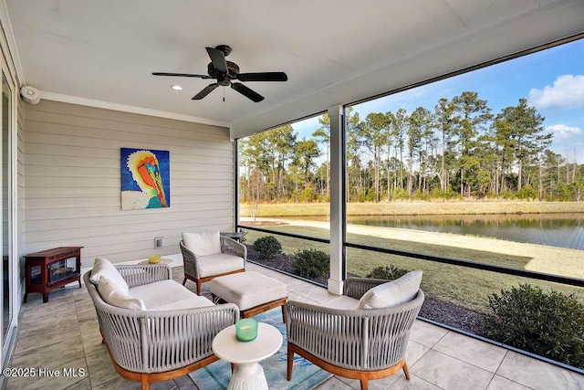 sunroom / solarium featuring a water view and ceiling fan