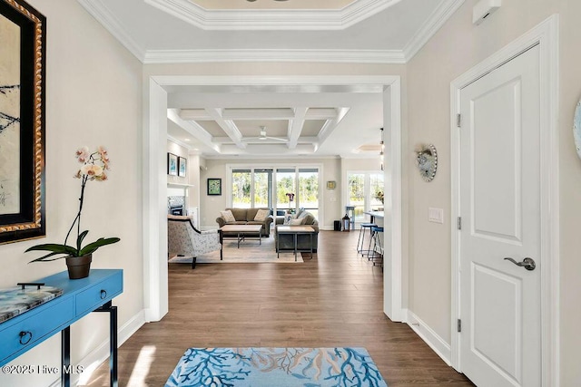 hallway with hardwood / wood-style floors, crown molding, beamed ceiling, and coffered ceiling