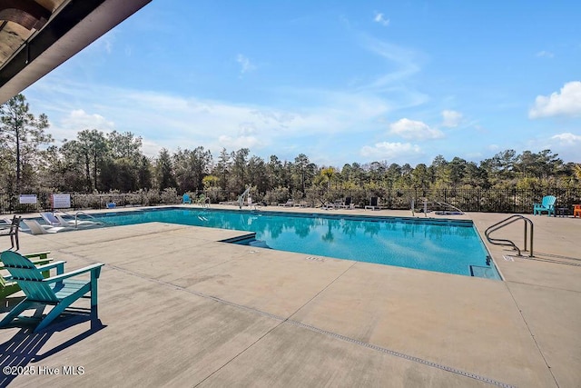 view of swimming pool with a patio