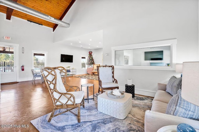 living room featuring wooden ceiling, concrete flooring, beam ceiling, and high vaulted ceiling