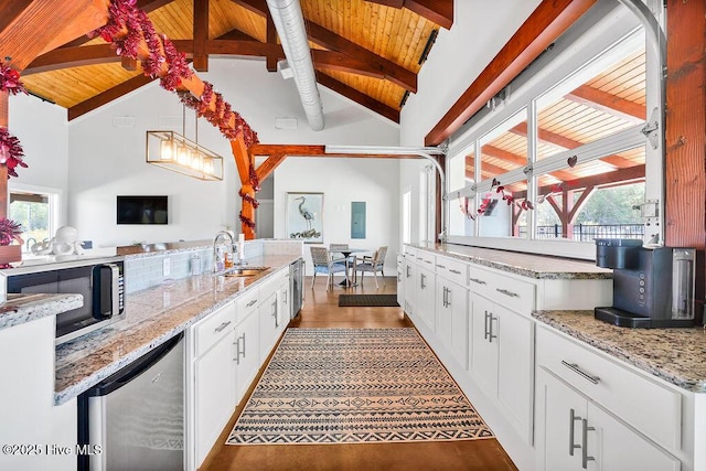 kitchen with wooden ceiling, white cabinets, and sink