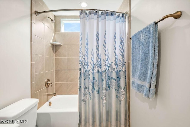 bathroom featuring toilet and shower / bath combination with curtain