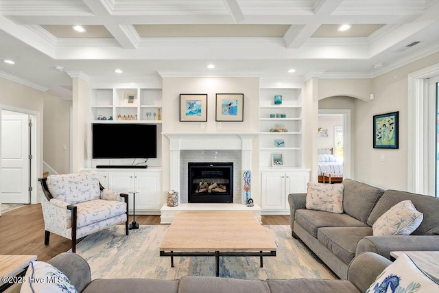 living room featuring beam ceiling, ornamental molding, and coffered ceiling