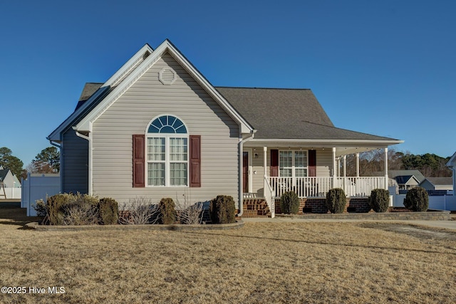 view of front facade with covered porch and a front lawn