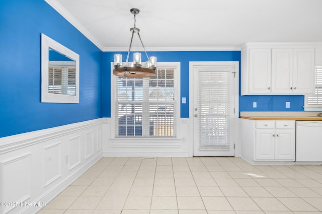 unfurnished dining area featuring light tile patterned flooring, a chandelier, and ornamental molding