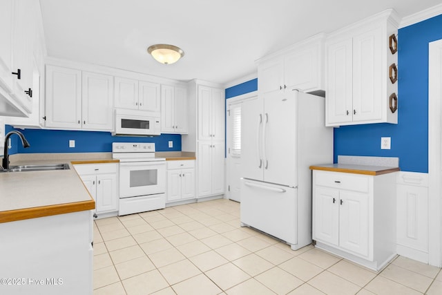 kitchen featuring white appliances, white cabinetry, ornamental molding, and sink