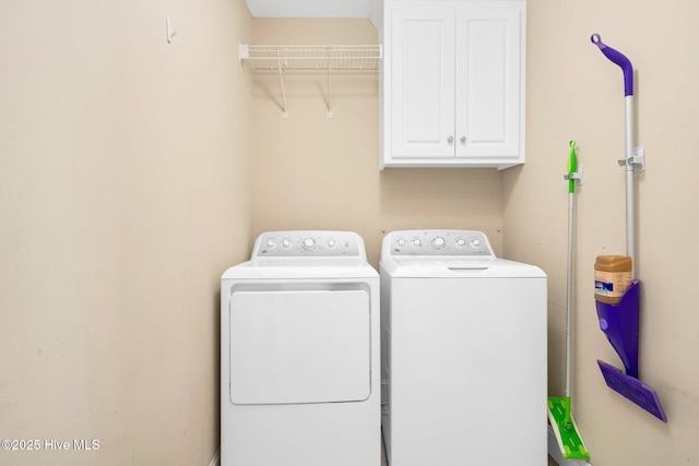 laundry area featuring cabinets and washer and clothes dryer