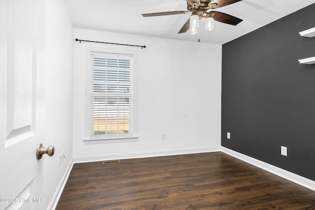 spare room with ceiling fan and dark wood-type flooring