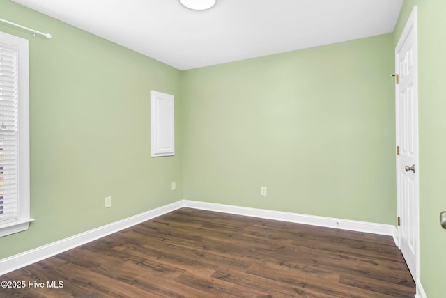 empty room featuring dark hardwood / wood-style flooring