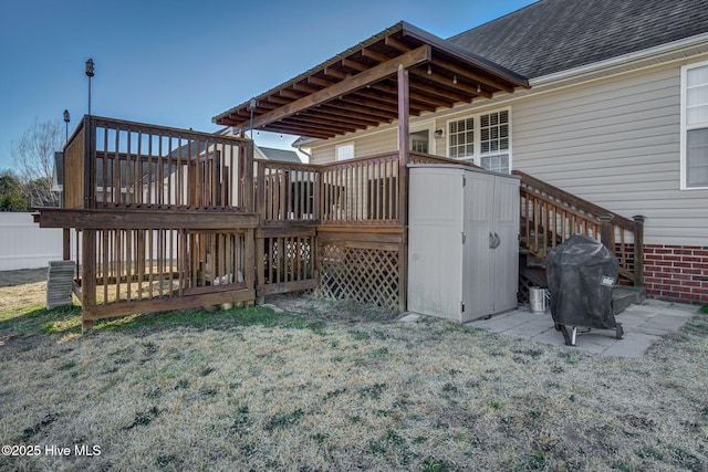 deck featuring grilling area and a yard