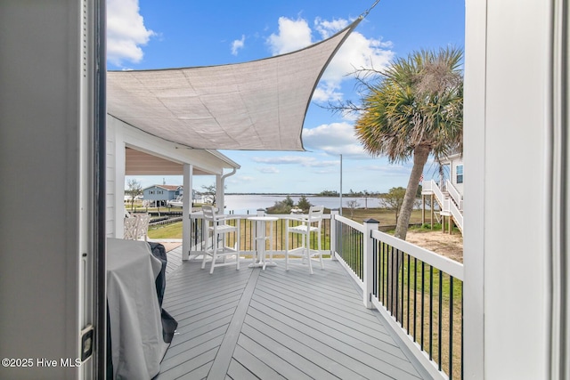 wooden deck featuring a water view