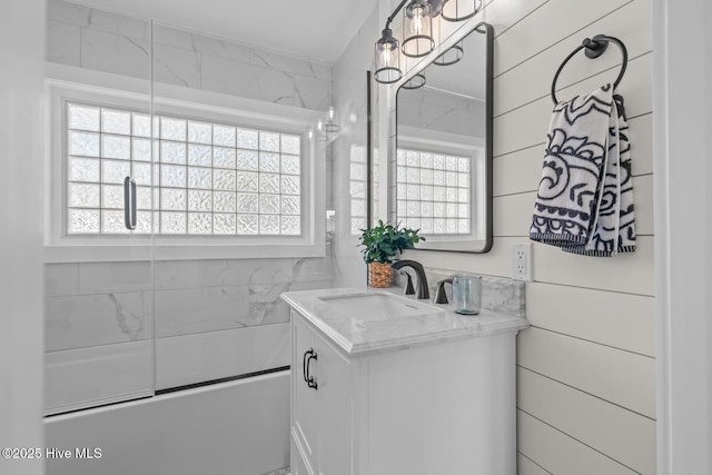 bathroom with vanity and enclosed tub / shower combo