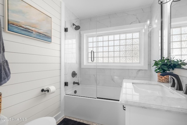 full bathroom featuring enclosed tub / shower combo, a healthy amount of sunlight, vanity, and toilet