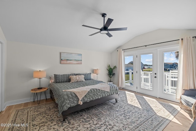 bedroom with vaulted ceiling, hardwood / wood-style floors, access to exterior, ceiling fan, and french doors