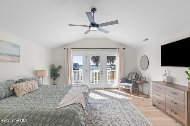 bedroom with french doors, vaulted ceiling, light wood-type flooring, ceiling fan, and access to exterior