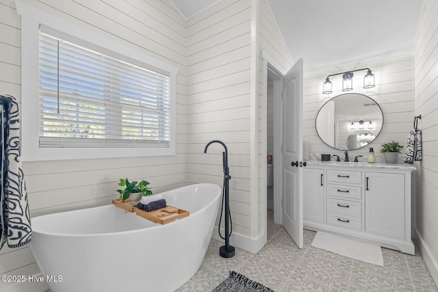 bathroom with a tub to relax in, wooden walls, and vanity