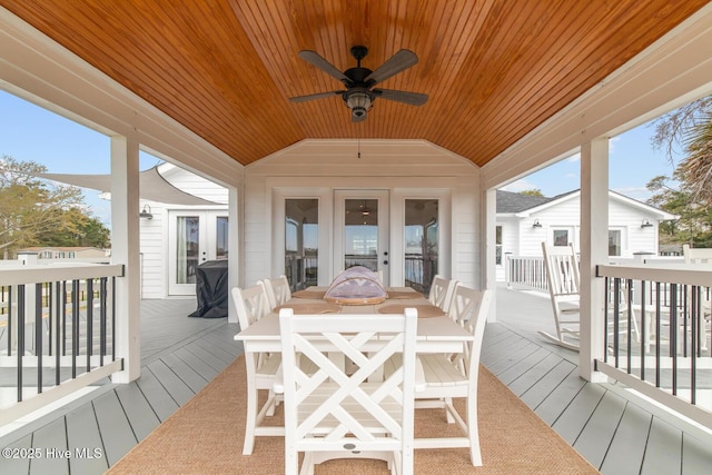 sunroom with vaulted ceiling, plenty of natural light, wooden ceiling, and french doors