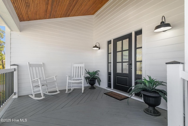 view of exterior entry featuring covered porch