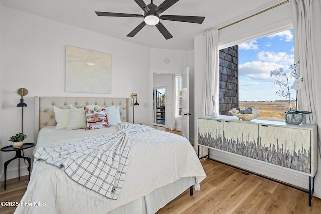 bedroom with hardwood / wood-style floors and ceiling fan