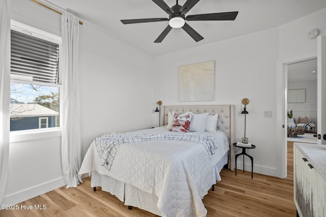 bedroom with ceiling fan and light wood-type flooring