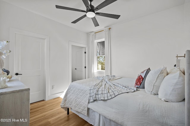 bedroom with light hardwood / wood-style floors and ceiling fan