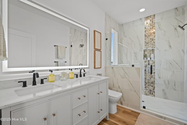 bathroom with vanity, toilet, an enclosed shower, and hardwood / wood-style floors