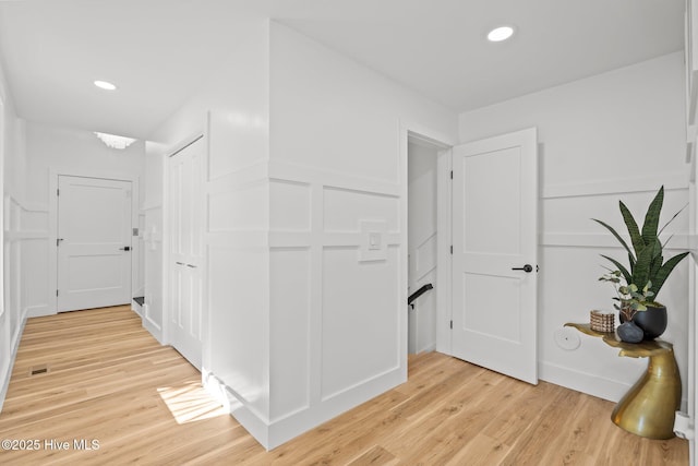 hallway with light hardwood / wood-style flooring