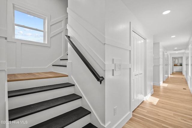 stairs with hardwood / wood-style floors