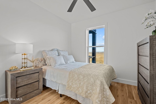 bedroom featuring vaulted ceiling, ceiling fan, and light hardwood / wood-style floors