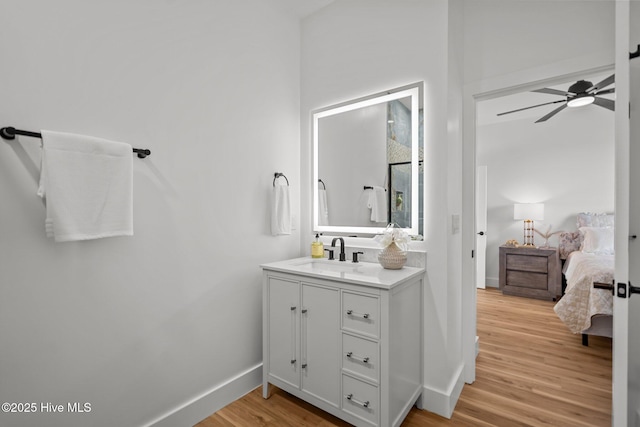 bathroom featuring vanity, wood-type flooring, and ceiling fan