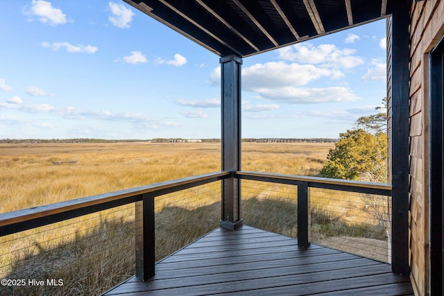 wooden deck with a rural view