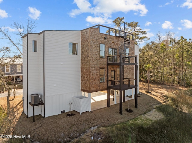 rear view of property featuring cooling unit