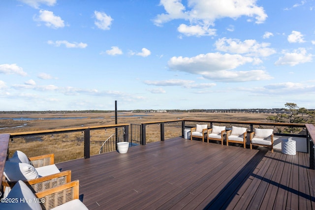 wooden deck with outdoor lounge area and a rural view