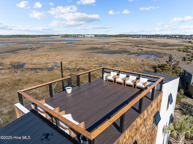 wooden deck featuring a water view and a rural view