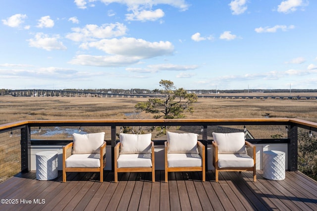 wooden deck with a rural view