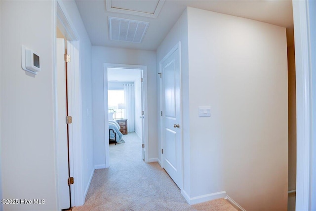 hallway with light colored carpet