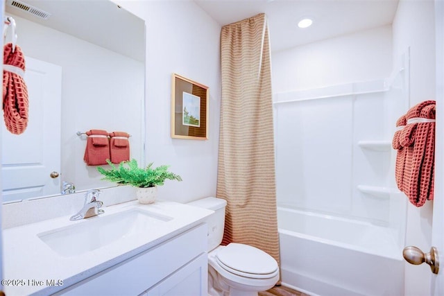 full bathroom featuring toilet, shower / bath combo, and vanity