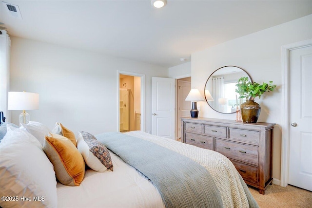 carpeted bedroom featuring ensuite bathroom