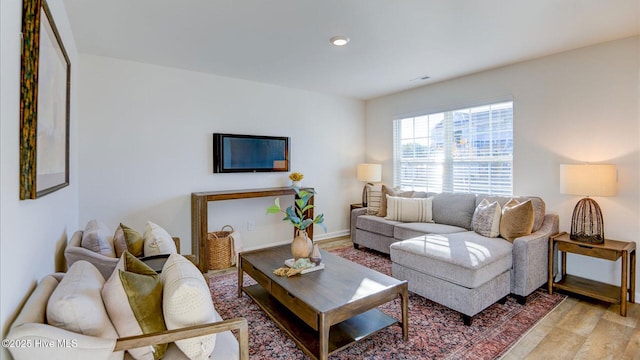 living area with light wood-style flooring and baseboards